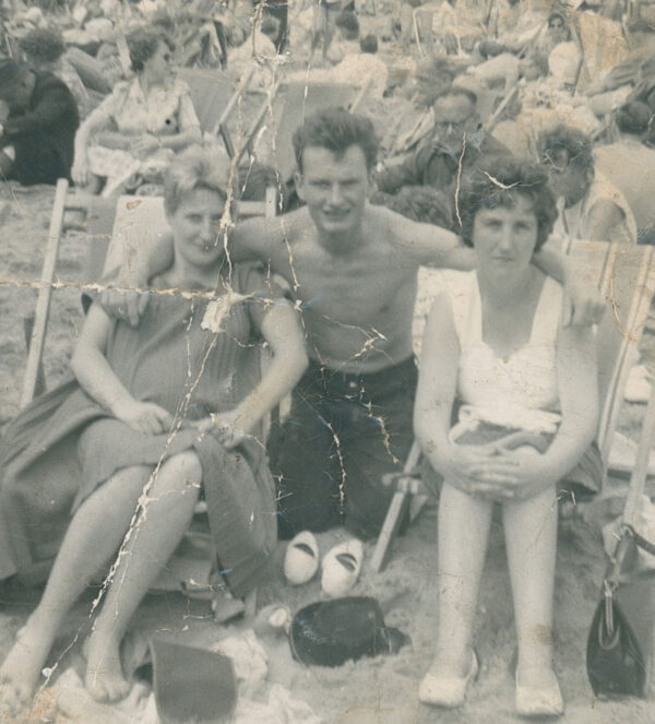 Damaged black and white image of friends at the beach